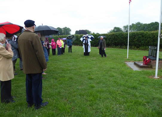 Mike Garrod addresses the congregation in the rain